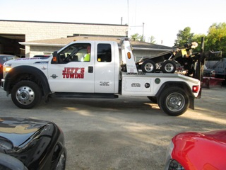 A Jeff's tow truck with a driver.